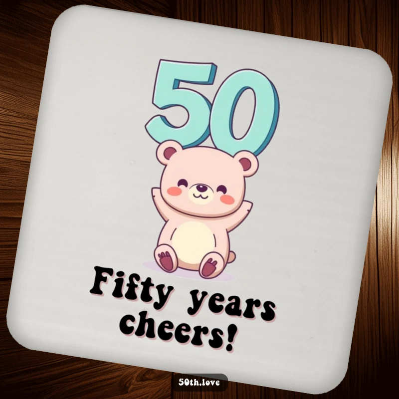 Funny 50th birthday drink coaster with a smiling bear balancing the number 50 on its head, protecting surfaces humorously.