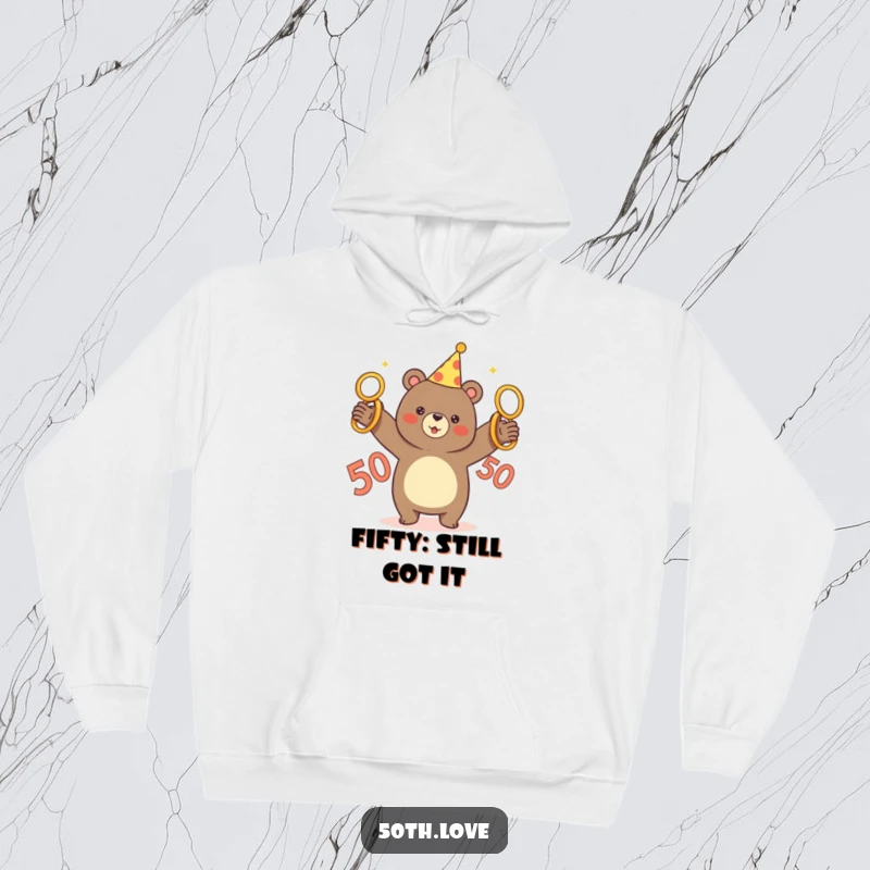 Funny hoodie with a cheerful bear in a party hat juggling five golden rings, with a big 50 nearby.