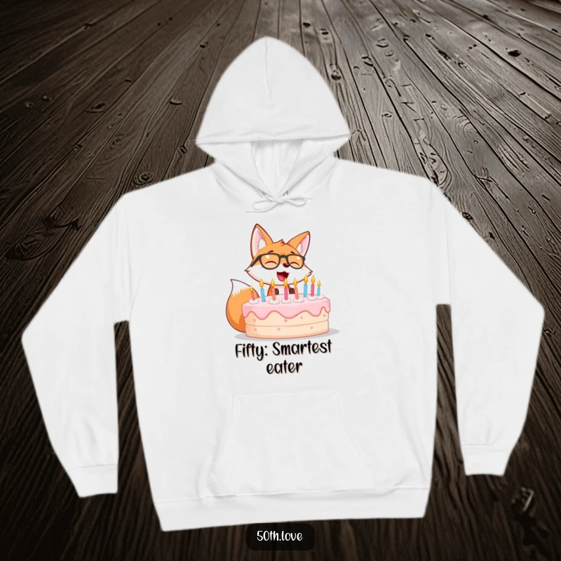 Funny hoodie featuring a giggling fox wearing spectacles, blowing out candles on a large birthday cake.
