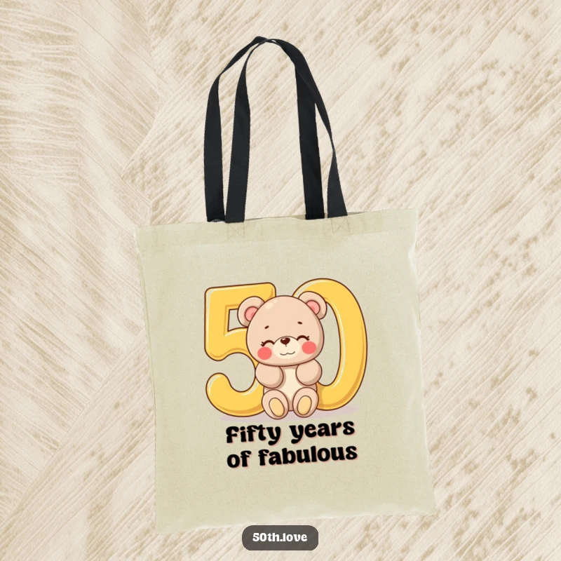 Funny '50th Birthday Bear' Tote Bag: A plush bear peeks out of a large golden number 50, offering a wink and birthday wishes.