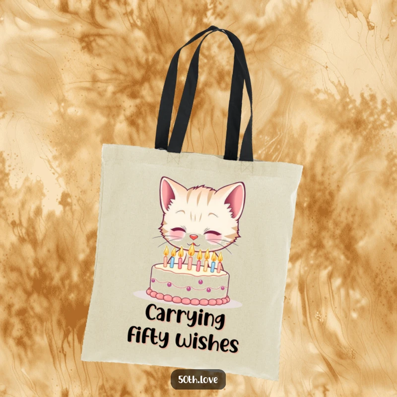 Funny 50th birthday tote bag with a smiling kitten attempting to blow out fifty tiny candles on a minuscule cake, a humorous accessory.